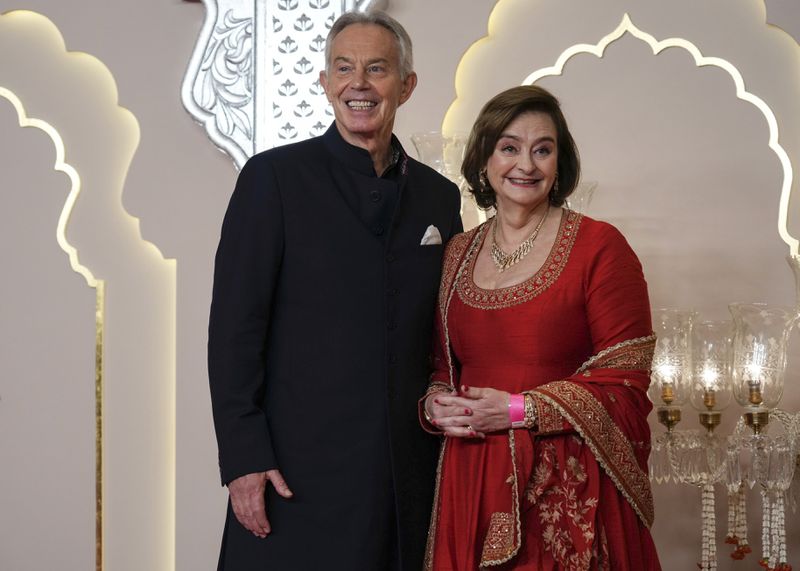 Former British Prime Minister Tony Blair poses for a photograph with his wife Cherie Blair at the wedding of Billionaire Mukesh Ambani's son Anant Ambani and Radhika Merchant at Jio World Convention Centre in Mumbai, India, Friday, July 12, 2024. (AP Photo /Rajanish Kakade)