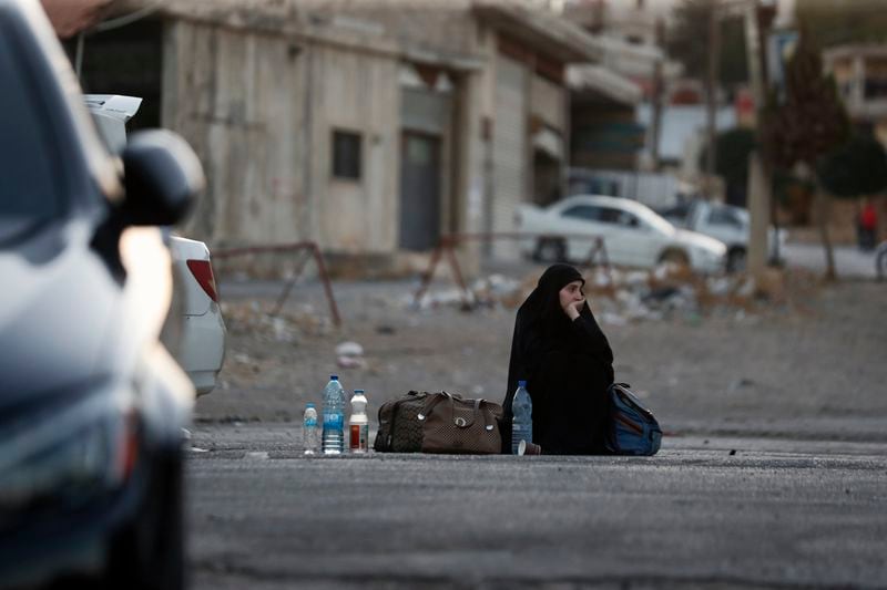 A Lebanese fleeing the Israeli bombardment, arrives at the Syrian-Lebanese border crossing in Jdaidet Yabous, Syria, Tuesday, Sept. 24, 2024. (AP Photo/Omar Sanadiki)