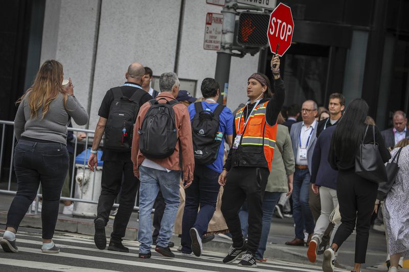 David Newlander escorts visitors to and from the Dreamforce conference in San Francisco, Tuesday, Sept. 17, 2024. (Brontë Wittpenn/San Francisco Chronicle via AP)