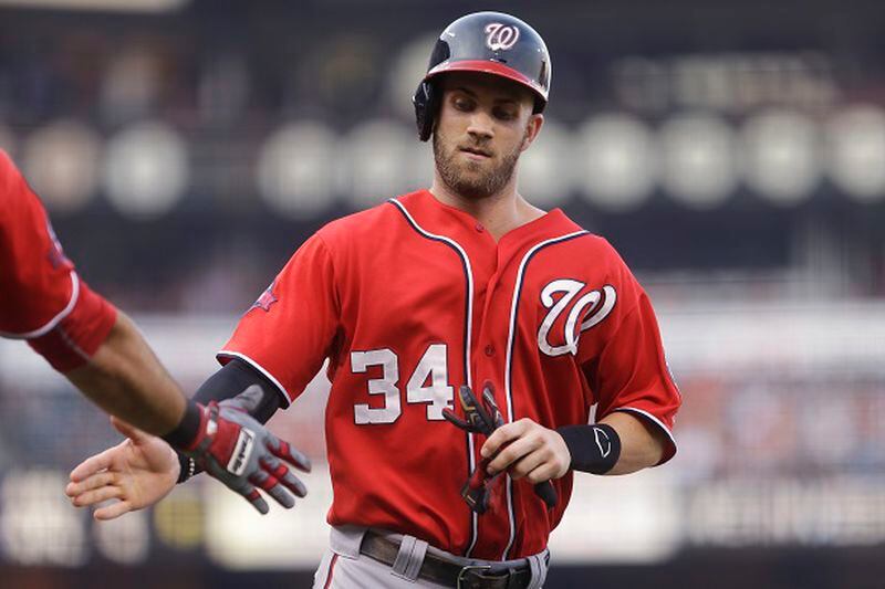 Washington Nationals' Bryce Harper is congratulated after scoring against the San Francisco Giants during the first inning of a baseball game Saturday, Aug. 15, 2015, in San Francisco. Harper scored on a double by Nationals' Yunel Escobar. (AP Photo/Ben Margot)