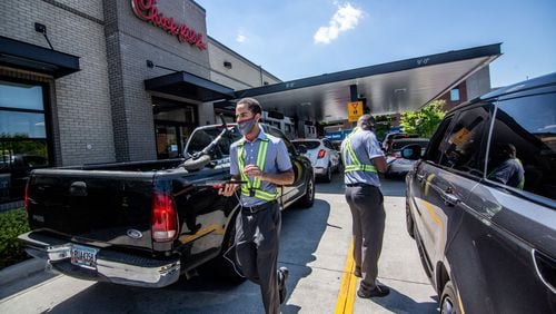 Employees direct traffic and take orders outside the Chick-fil-A on Northside Drive in Atlanta on Monday April 19, 2021. Sales for the overall Chick-fil-A chain were up last year, even with the pandemic, compared to the year before, according to company disclosure documents. STEVE SCHAEFER FOR THE ATLANTA JOURNAL-CONSTITUTION