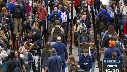 Travelers weave through a long line to get to the security checkpoint at Hartsfield-Jackson International Airport. STEVE SCHAEFER / SPECIAL TO THE AJC
