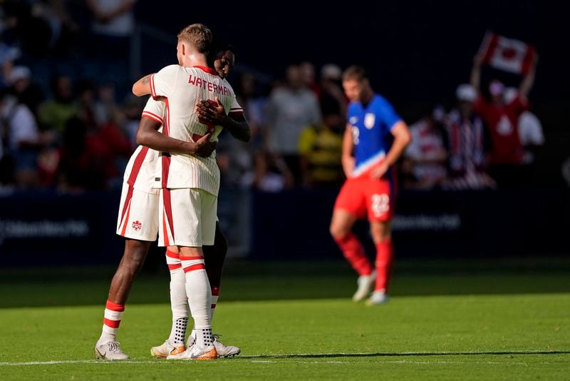 Canada defenders Moïse Bombito, and Joel Waterman (5) celebrate after their international friendly soccer game against United States , Saturday, Sept. 7, 2024, in Kansas City, Mo. Canada won 2-1. (AP Photo/Charlie Riedel)