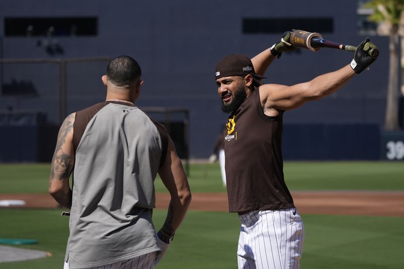 San Diego Padres' Fernando Tatis Jr. takes batting practice with Manny Machado, left, before Game 1 of an NL Wild Card Series baseball game against the Atlanta Braves, Tuesday, Oct. 1, 2024, in San Diego. (AP Photo/Gregory Bull)