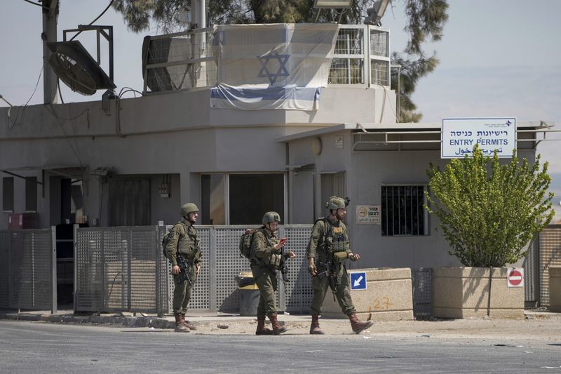 Israeli soldiers stand guard near the site of a deadly shooting attack where Israeli officials say three people were shot and killed at the Allenby Bridge Crossing between the West Bank and Jordan, Sunday, Sept. 8, 2024. (AP Photo/Mahmoud Illean)