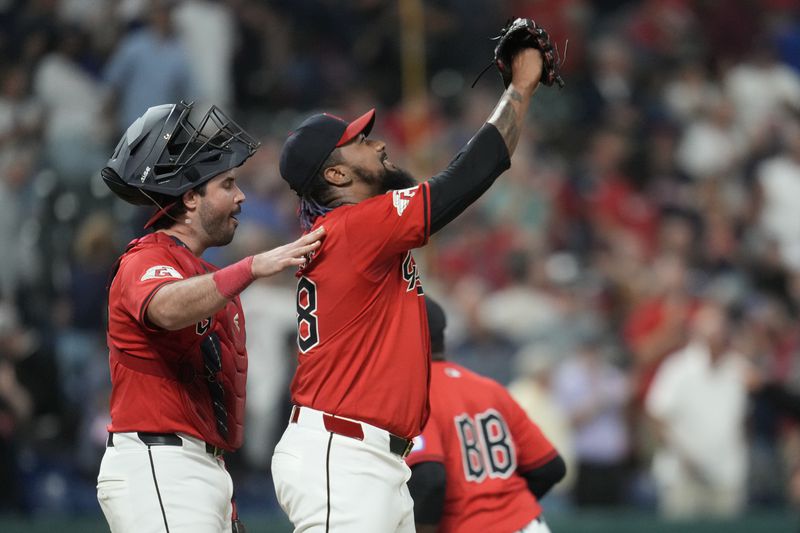 Cleveland Guardians relief pitcher Emmanuel Clase, front right, celebrates with catcher Austin Hedges, left, after they defeated the Minnesota Twins in a baseball game Monday, Sept. 16, 2024, in Cleveland. (AP Photo/Sue Ogrocki)