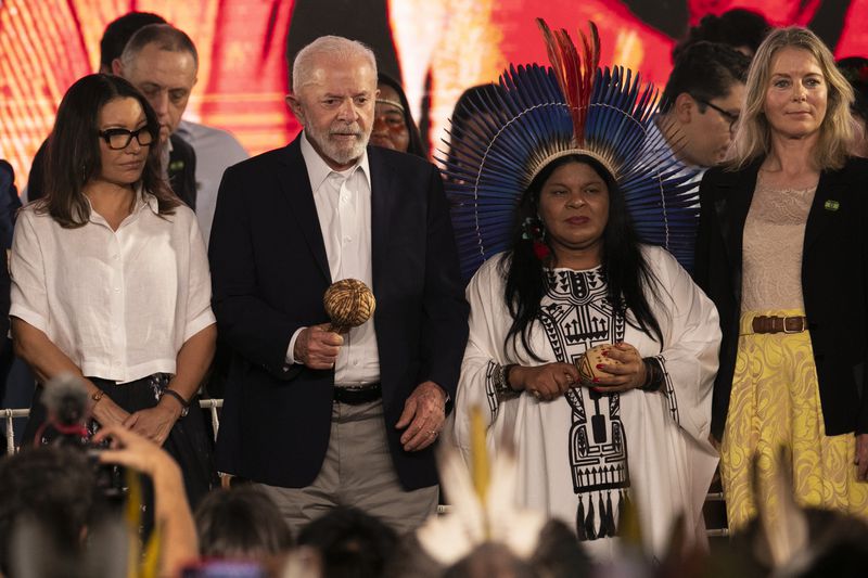 Brazil's President Luiz Inacio Lula da Silva, second from left, Minister for Indigenous Peoples Sonia Guajajara, second from right, and Denmark's Ambassador to Brazil Eva Bisgaard Pederson, right, attend a ceremony celebrating the return of the Indigenous Tupinamba people's sacred cloak to Brazil, in Rio de Janeiro, Thursday, Sept. 12, 2024. The garment, made from bird feathers and plant fibers, was repatriated to Brazil after having spent more than 300 years in the National Museum of Denmark. (AP Photo/Bruna Prado)