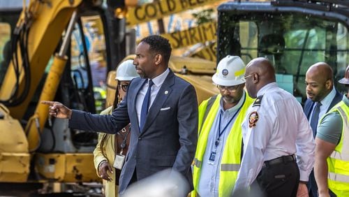 Atlanta, Mayor Andre Dickens said Monday that he took criticism from the public "to heart." Crews are continuing to work on a broken main on West Peachtree Street in Midtown, with nearby residents warned of impacts to their water service as the crisis reached its fourth day Monday, June 3, 2024. Water had been gushing out of the broken main until Monday morning, when workers were seen pumping out water. (John Spink/AJC)