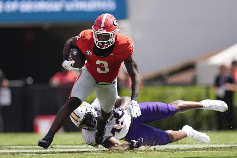 Georgia running back Nate Frazier (3) break away from Tennessee Tech linebacker Kalvyn Crummie (42) during the first half of an NCAA college football game Saturday, Sept. 7, 2024, in Athens, Ga. (AP Photo/John Bazemore)