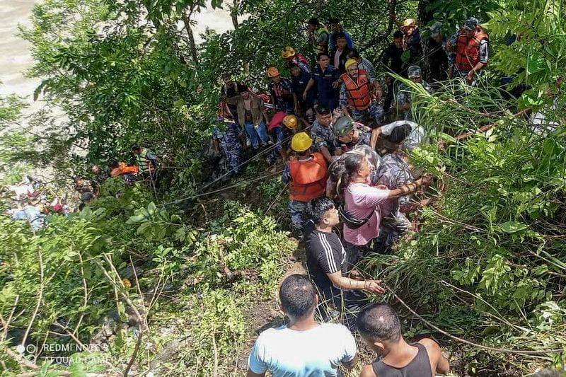 This photograph provided by Nepal Armed Police Force (APF) shows APF personnel carrying out rescue operation after a bus carrying Indian pilgrims fell into a river near Abukhaireni town, about 75 miles west of the capital, Kathmandu, Nepal, Friday, Aug. 23, 2024. (Nepal Armed Police Force via AP)