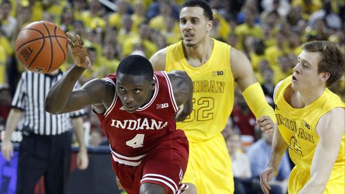 Indiana guard Victor Oladipo (4) drives to the basket while pursued by Michigan forward Jordan Morgan (52) and guard Spike Albrecht (2) during the first half of an NCAA college basketball game Sunday, March 10, 2013, in Ann Arbor, Mich. (AP Photo/Duane Burleson)