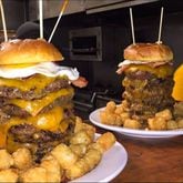 The John Henry Challenge at Local 7 in Tucker includes seven burger patties with a fried egg and cheese, along with tater tots or fries. / Courtesy of Local 7