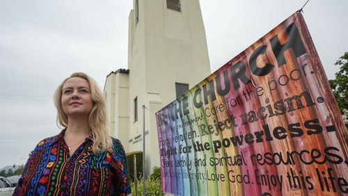 Pastor Ruth Schmidt poses for a picture at the Altadena Community Church in Altadena, Calif., on Tuesday, May 21, 2024. Schmidt, who now serves as a pastor at Claremont Presbyterian Church and is on track to be ordained in the United Church of Christ, said she would like to see faculty and staff at Fuller get the same protections as students. Fuller Theological Seminary, an evangelical school is deliberating whether to become more open to LGBTQ+ students who previously faced possible expulsion if found to be in a same-sex union. (AP Photo/Damian Dovarganes)