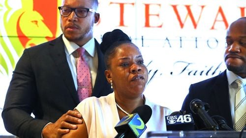 Rayshard Brooks’ widow, Tomika Miller, is moved to tears after learning new details of her husband’s death while addressing the media with family attorneys L. Chris Stewart (right) and Justin Miller (left) at Stewart Trial Attorneys on Wednesday, June 17, 2020, in Atlanta. Fulton County District Attorney Paul Howard had just announced that former Atlanta Police officer Garrett Rolfe, who shot Brooks twice during a suspected DUI arrest, would be charged with felony murder. Curtis Compton ccompton@ajc.com