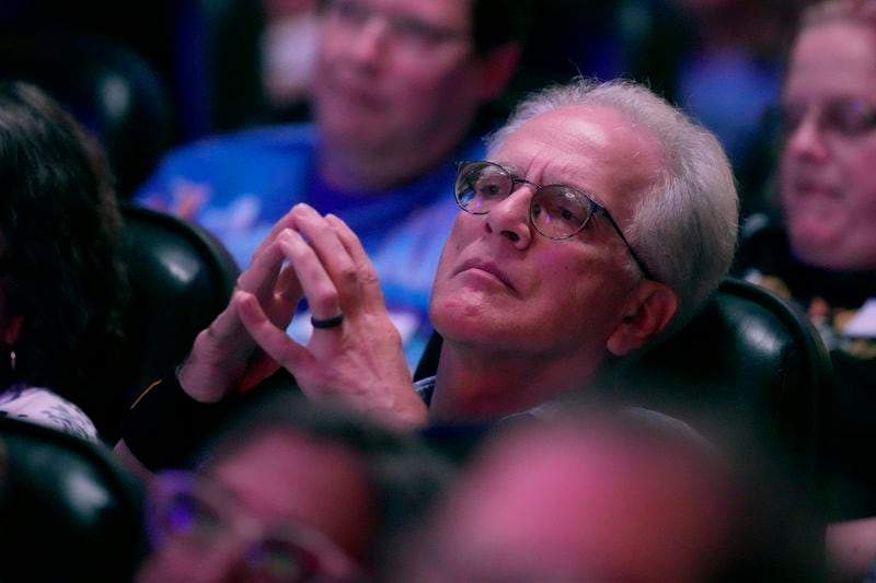 People watch the presidential debate between Republican presidential nominee former President Donald Trump and Democratic presidential nominee Vice President Kamala Harris at the Aztec theater Tuesday, Sept. 10, 2024, in Shawnee, Kan. (AP Photo/Charlie Riedel)