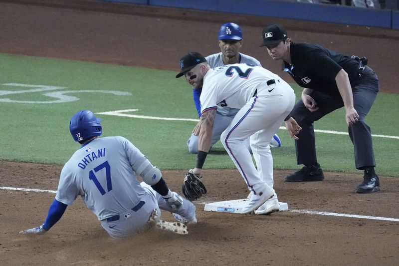 Miami Marlins third baseman Connor Norby tags out Los Angeles Dodgers' Shohei Ohtani (17) of Japan, after Ohtani attempted to stretch out a double during the third inning of a baseball game, Thursday, Sept. 19, 2024, in Miami. (AP Photo/Wilfredo Lee)