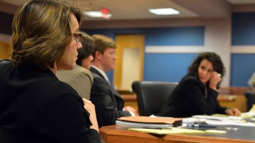 Stacey Kalberman (left) listens to arguments as Judge Ural Glanville presides over Kalberman's whistleblower lawsuit in Fulton County Superior Court Monday, March 31, 2014.