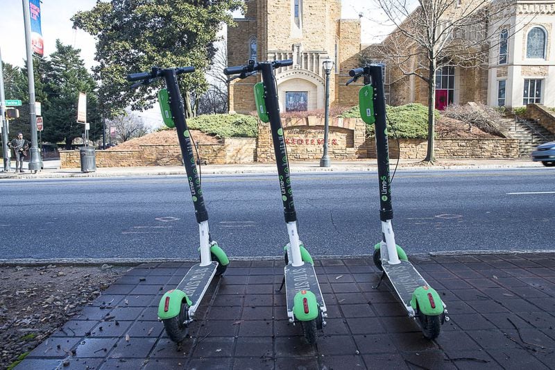 Lime scooters sit parked on the sidewalk on Peachtree Street in Midtown on Jan. 4, 2019. (ALYSSA POINTER/ALYSSA.POINTER@AJC.COM)