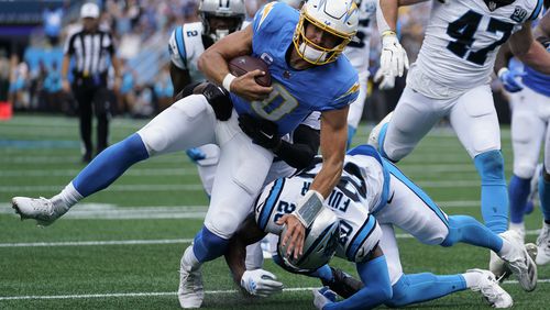 Los Angeles Chargers quarterback Justin Herbert runs against the Carolina Panthers during the first half of an NFL football game on Sunday, Sept. 15, 2024, in Charlotte, N.C. (AP Photo/Erik Verduzco)