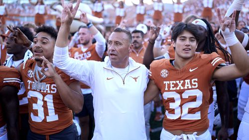 Texas head coach Steve Sarkisian, center, joins players for the school song following their win over Mississippi State in an NCAA college football game in Austin, Texas, Saturday, Sept. 28, 2024. (AP Photo/Eric Gay)