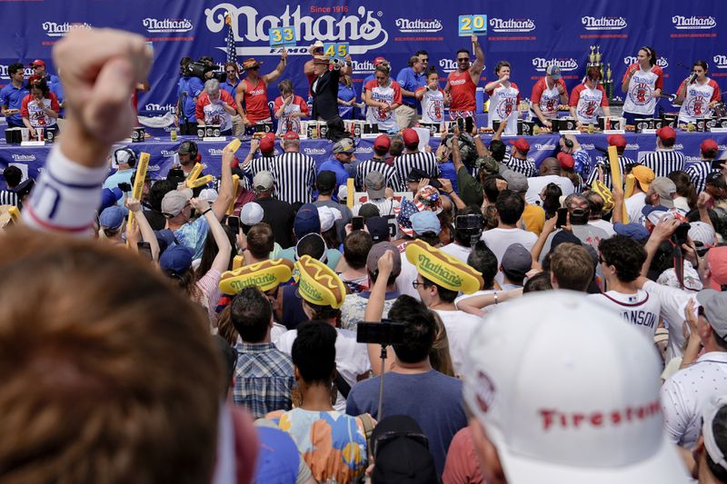 Competitive eaters participate in the women's division in Nathan's Famous Fourth of July hot dog eating contest, Thursday, July 4, 2024, at Coney Island in the Brooklyn borough of New York. (AP Photo/Julia Nikhinson)