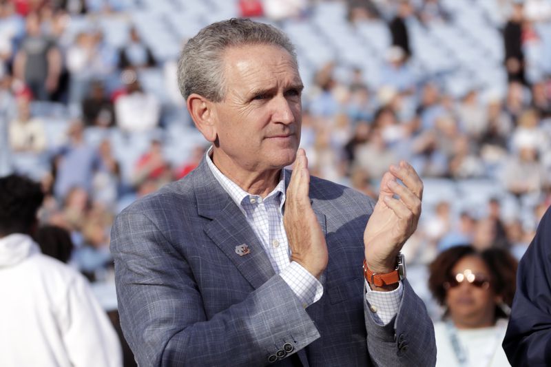 FILE - North Carolina athletic director Bubba Cunningham applauds the seniors before an NCAA college football game against North Carolina State Friday, Nov. 25, 2022, in Chapel Hill, N.C. (AP Photo/Chris Seward, file)