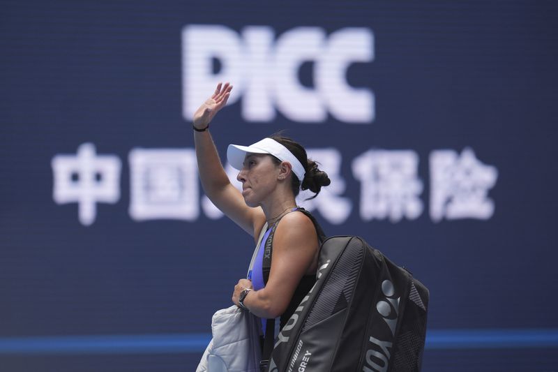 Jessica Pegula of the United States waves as she leaves after losing to Paula Badosa of Spain in a women's singles match for the China Open tennis tournament held at the National Tennis Center in Beijing, Tuesday, Oct. 1, 2024. (AP Photo/Ng Han Guan)