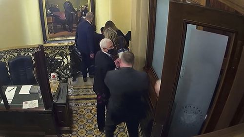 In this image from video, a security video shows Vice President Mike Pence being evacuated from near the Senate chamber as rioters breach the Capitol, on Jan. 6, 2021, at the Capitol in Washington. (Senate Television via AP)