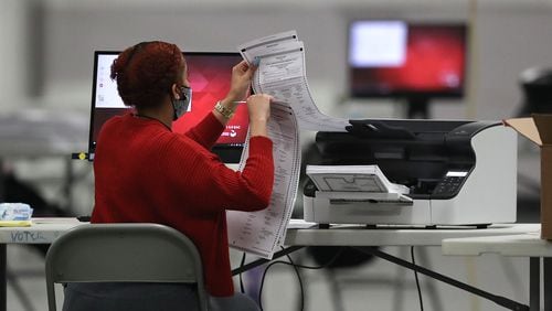 DeKalb County election workers scan ballots to recount more votes in the 2020 presidential election. Curtis Compton / Curtis.Compton@ajc.com