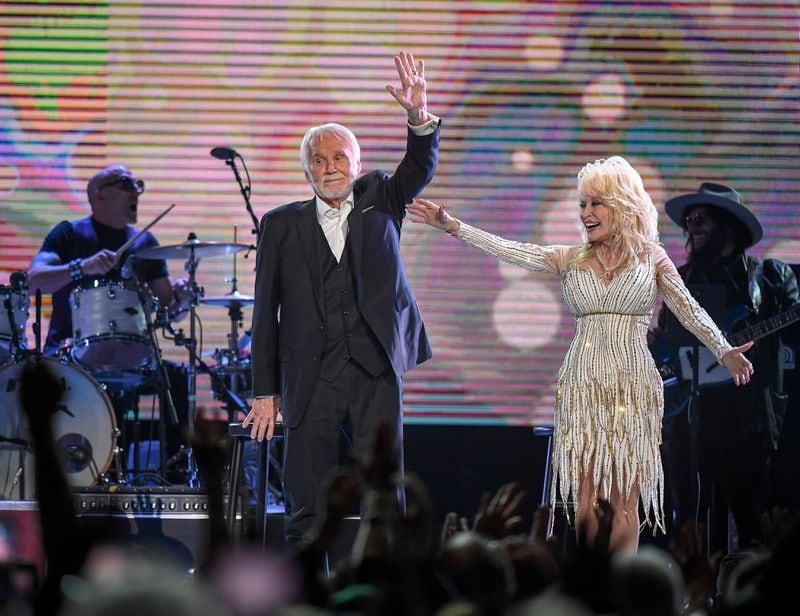 Kenny Rogers and Dolly Parton wave good-bye to the crowd after performing for the last time at the All In For the Gambler tribute to Kenny Rogers at the Bridgestone Arena in Nashville, Tenn., Wednesday, Oct. 25, 2017.