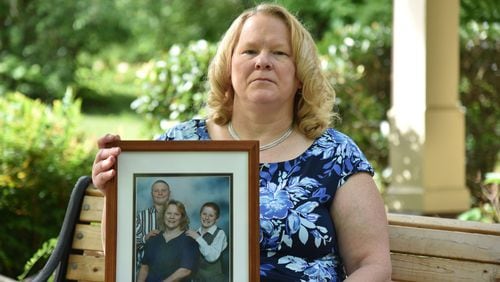 May 3, 2017 Norcross - Debra Baldwin holds a family photograph that was taken with her two sons Austin (left) and Nicholas on Wednesday, May 3, 2017. Debra Baldwin is the mother of a former inmate who survived a suicide attempt. An inmate's mother made several phone calls to the Georgia State Prison at Reidsville to alert them she feared her son would try to kill himself. A counselor spoke with the inmate who was have auditory and visual hallucinations. The scheduled an appointment to have him evaluated the next week. That same day he tried to kill himself. He survived but is comatose and now a ward of the state for the rest of his life. HYOSUB SHIN / HSHIN@AJC.COM