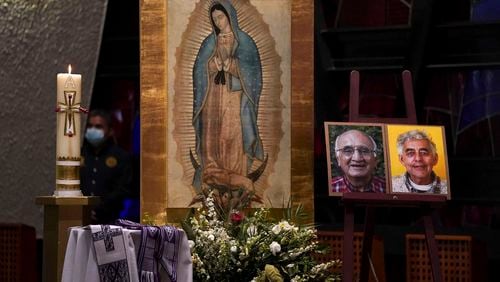 FILE - Framed images of Jesuit priests Javier Campos Morales, left, and Joaquin Cesar Mora Salazar are displayed on an altar during a memorial Mass in Mexico City, June 21, 2022. Two years have passed since a leader of one of Mexico’s organized crime stormed into a Catholic church in the remote Tarahumara mountains and shot the two Jesuit priests to death on June 20, 2022. (AP Photo/Fernando Llano, File)
