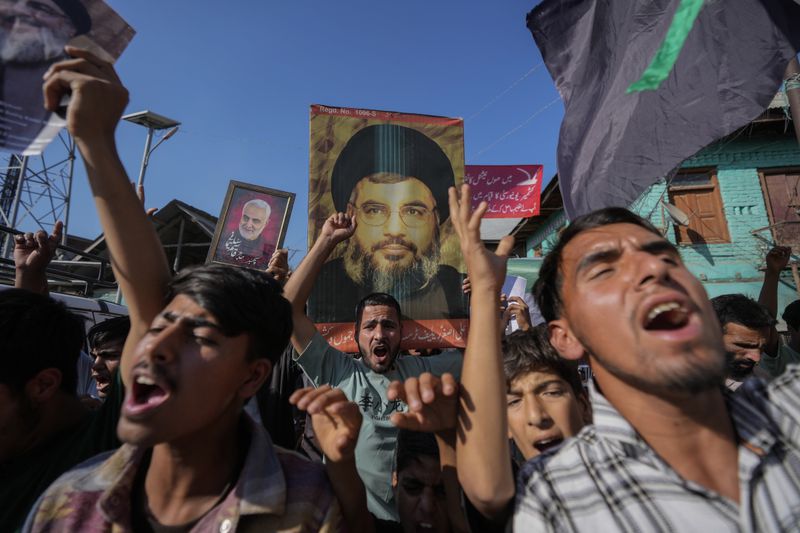 Kashmiri Shiite Muslims shout pro-Palestine and anti-Israel slogans during a protest in solidarity with Palestine and against the killing of Hezbollah leader Hassan Nasrallah, at Mirgund north village of Srinagar, Indian controlled Kashmir, Friday, Oct. 4, 2024. (AP Photo/Mukhtar Khan)