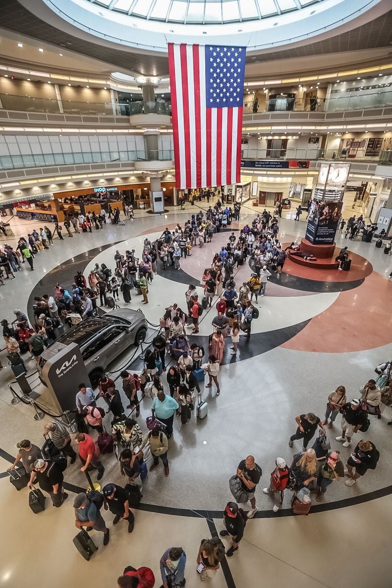 Lines for the main security checkpoint at Hartsfield-Jackson International Airport stretched through the domestic terminal atrium on Friday, June 28, 2024. Credit: John Spink / jspink@ajc.com