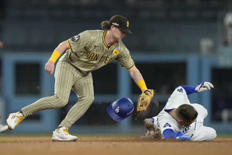 Los Angeles Dodgers' Freddie Freeman, right, steals second base against San Diego Padres second baseman Jake Cronenworth, left, during the third inning in Game 1 of baseball's NL Division Series Saturday, Oct. 5, 2024, in Los Angeles. (AP Photo/Mark J. Terrill)