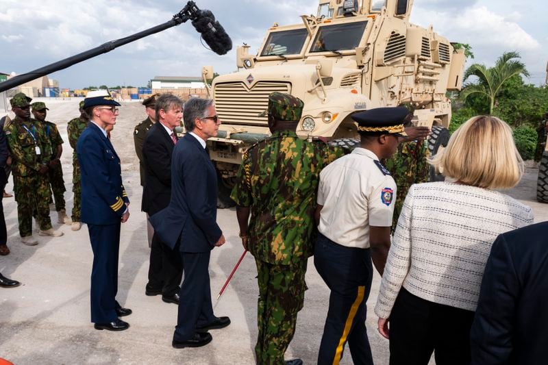 Commander of the Multinational Security Support Mission Commander Godfrey Otunge, third from right, shows U.S. Secretary of State Antony Blinken, fourth from right, armored vehicles the U.S. government donated at the MSS base in Port-au-Prince, Haiti, Thursday, Sept. 5, 2024. (Roberto Schmidt/Pool photo via AP)