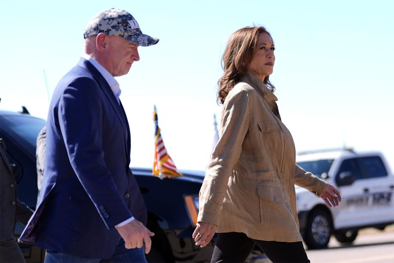 Democratic presidential nominee Vice President Kamala Harris followed by Sen. Mark Kelly, D-Ariz., walks after arriving in Douglas, Ariz., Friday, Sept. 27, 2024. (AP Photo/Carolyn Kaster)