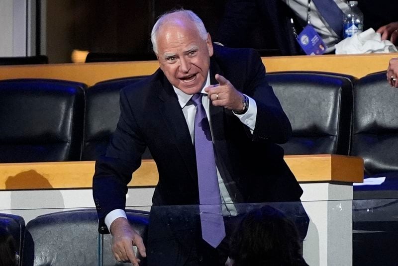 Democratic vice presidential nominee Minnesota Gov. Tim Walz gestures during the Democratic National Convention Monday, Aug. 19, 2024, in Chicago. (AP Photo/Charles Rex Arbogast)