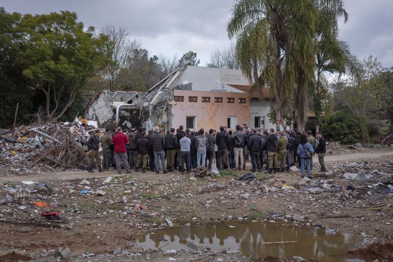 A group of Israelis visit a damaged house following the Oct. 7 Hamas militants attack on Israel in Kibbutz Beeri, southern Israel, on Friday, Jan. 28, 2024. A new kind of tourism has emerged in Israel in the months since Hamas’ Oct. 7 attack. For celebrities, politicians, influencers and others, no trip is complete without a somber visit to the devastated south that absorbed the brunt of the assault near the border with Gaza. (AP Photo/Oded Balilty)