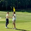 Garrett Engle (L) accepts congratulations from his opponent's caddie after tapping in on the 18th hole Engle, who plays at Tennessee-Chattanooga, won by shots at Druid Hills Golf Club, June 8, 2024.