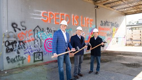 Demolition has begun to make way for a mixed-use space at 14th Street and Howell Mill Road. From left to right: Jeff Garrison, Steve Collins and Jeff DeHart with S.J. Collins Enterprises at the demo-day event. CONTRIBUTED
