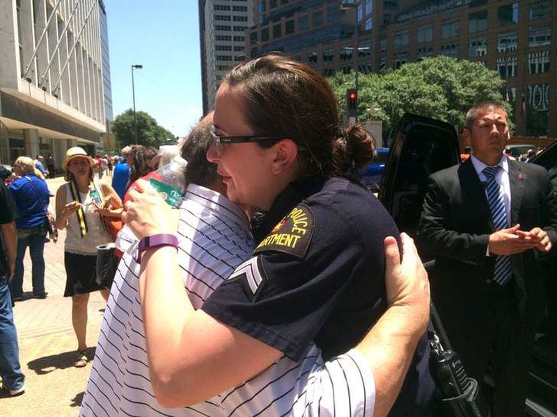 Dallas Police Senior Cpl. Debra Webb hugs a resident after a prayer service in downtown Dallas Friday afternoon. Photo: Jennifer Brett, jbrett@ajc.com