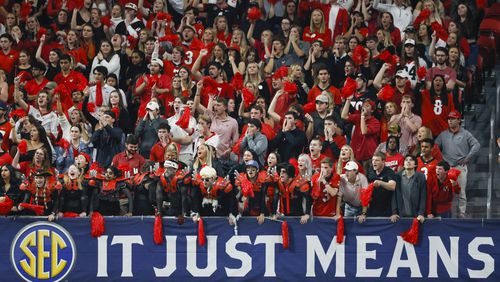 The spike squad and other Georgia students cheer under a SEC It Just Means More sign during Georgia’s game against the LSU Tigers during the SEC Championship game at Mercedes-Benz Stadium, Saturday, December 3, 2022, in Atlanta. Georgia won 50-30. Jason Getz / Jason.Getz@ajc.com)
