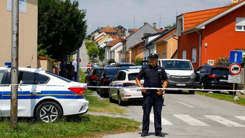 A police officer stands near the crime scene in Daruvar, central Croatia, Monday, July 22, 2024. An armed assailant entered a care home for older people in central Croatia Monday and opened fire, killing five people and wounding several others, authorities and media reports said. (Zeljko Puhovski/Cropix via AP)