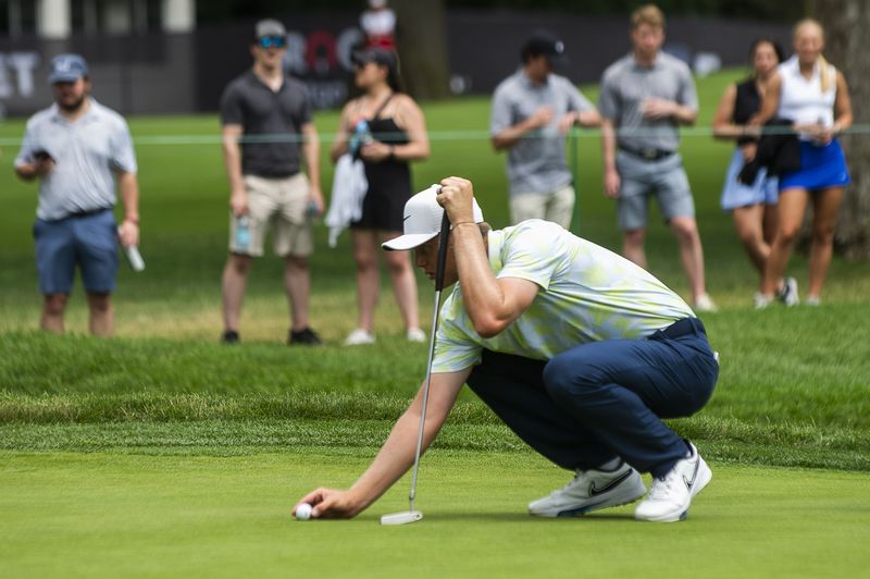 Cam Davis lines up a putt in the third ound of the PGA Rocket Mortgage Classic golf tournament, Saturday, June 29, 2024, at the Detroit Golf Club in Detroit. (Katy Kildee/Detroit News via AP)