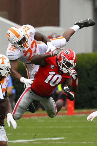 Georgia wide receiver Kearis Jackson (10) gets a pass reception interfeered with by Tennessee defensive back Jaylen McCollough (22)during the first half of a football game Saturday, Oct. 10, 2020, at Sanford Stadium in Athens. JOHN AMIS FOR THE ATLANTA JOURNAL- CONSTITUTION