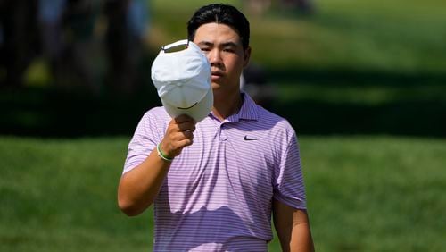 Tom Kim, of South Korea, walks on the ninth green during the second round of the Travelers Championship golf tournament at TPC River Highlands, Friday, June 21, 2024, in Cromwell, Conn. (AP Photo/Seth Wenig)