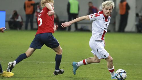 Georgia's Saba Lobjanidze, right, fights for the ball with Norway's Birger Meling during the Euro 2024 group A qualifying soccer match between Georgia and Norway at the AdjaraBet Arena in Batumi, Georgia, Tuesday, March 28, 2023. (AP Photo/Zurab Tsertsvadze)