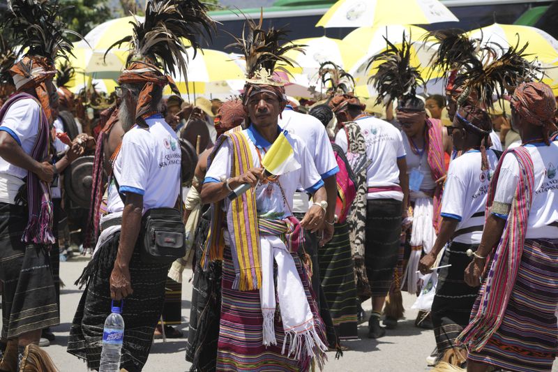 East Timorese wearing traditional dresses wait for Pope Francis' arrival outside of the Dili Presidente Nicolau Lobato International Airport in Dili, East Timor, Monday, Sept. 9, 2024. (AP Photo/Firdia Lisnawati)