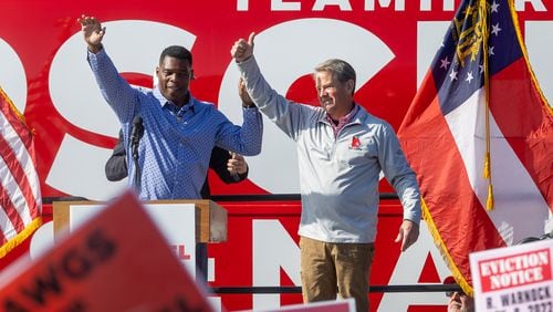 Gov. Brian Kemp (right) and Republican U.S. Senate hopeful Herschel Walker wave to the crowd at the end of a rally in Smyrna Saturday, November 19, 2022.   (Steve Schaefer/steve.schaefer@ajc.com)